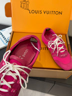 Unisex pink sneakers close-up: white laces, stitched side seams, low sole