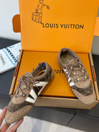 Gray suede sneakers with white side stripe, lace-up front and star emblem