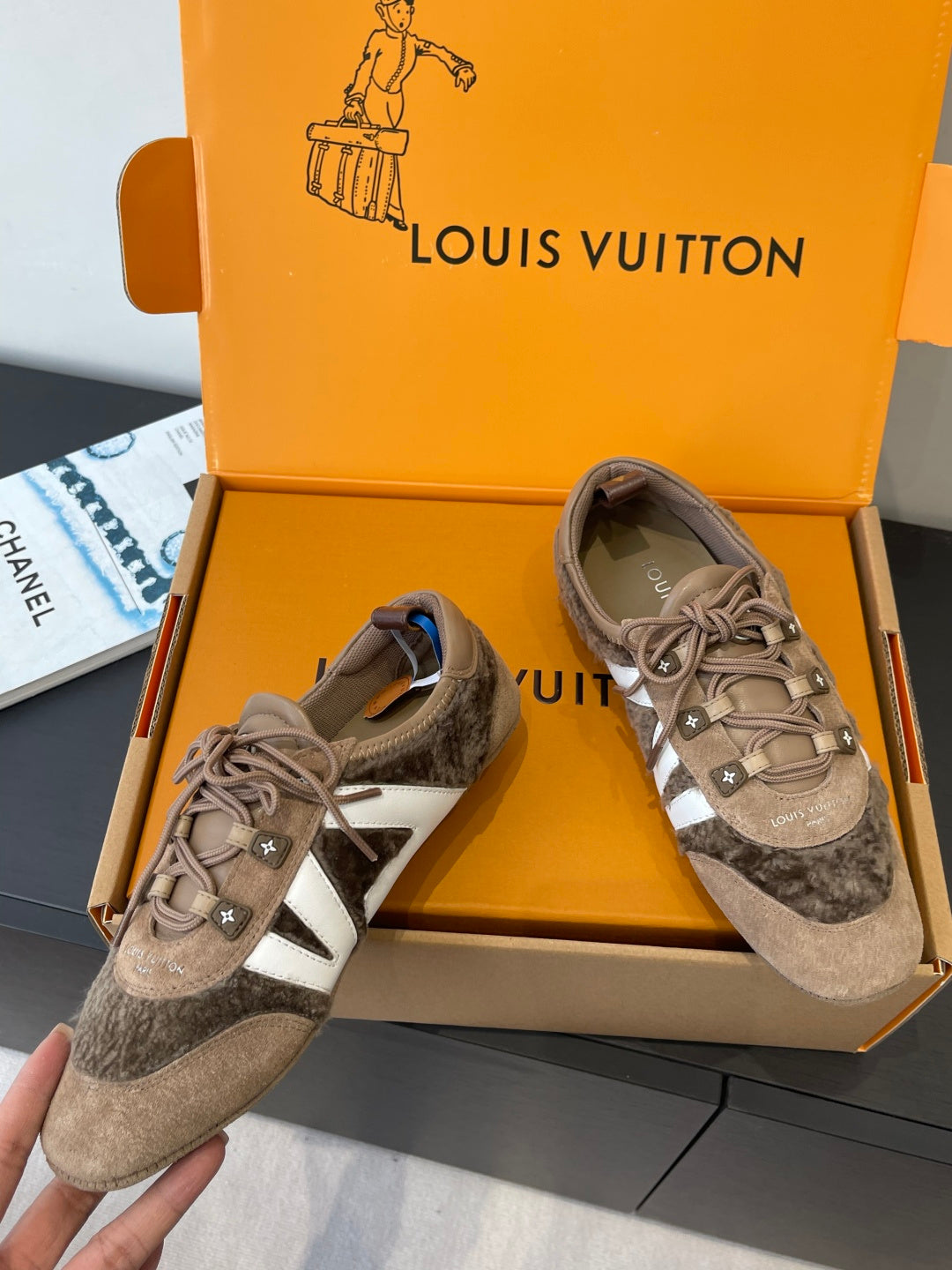 Gray suede sneakers with white side stripe, lace-up front and star emblem