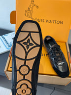 Black sneaker outsole view with LV monogram and flower detail