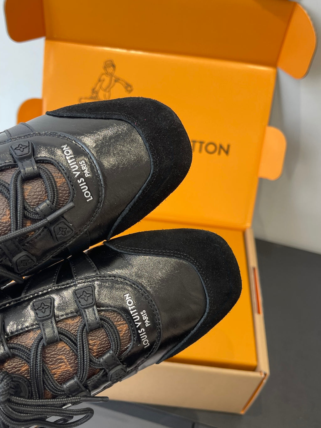 Black Louis Vuitton sneakers with logo label on heel and laces