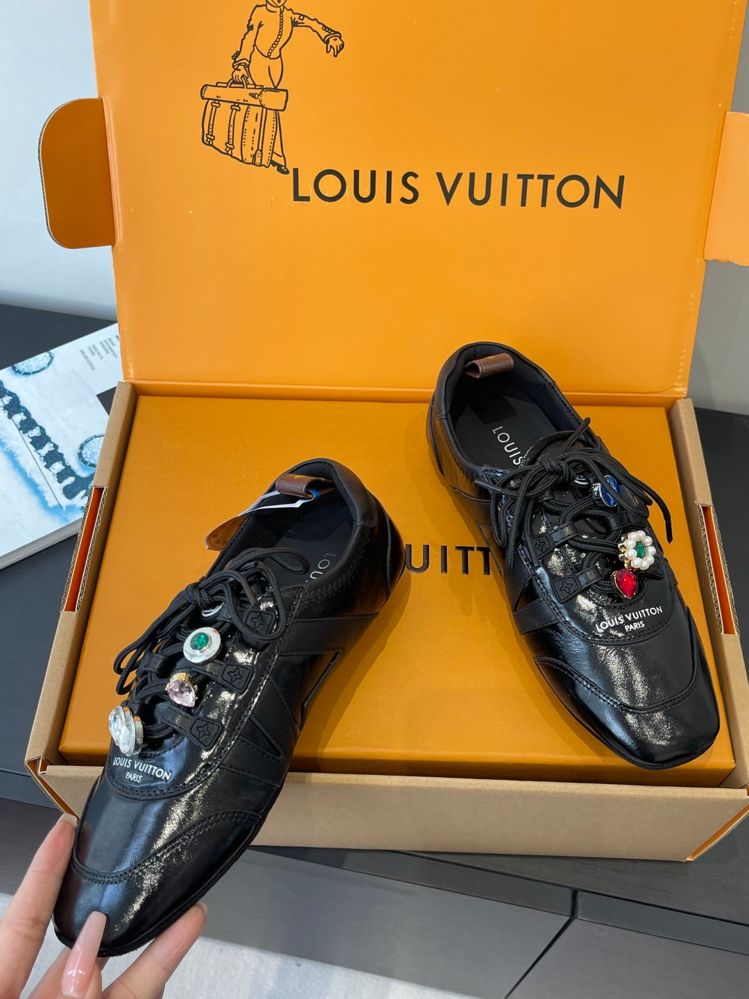 Louis Vuitton unisex black lace-up sneakers with jewel-like charms, close angle