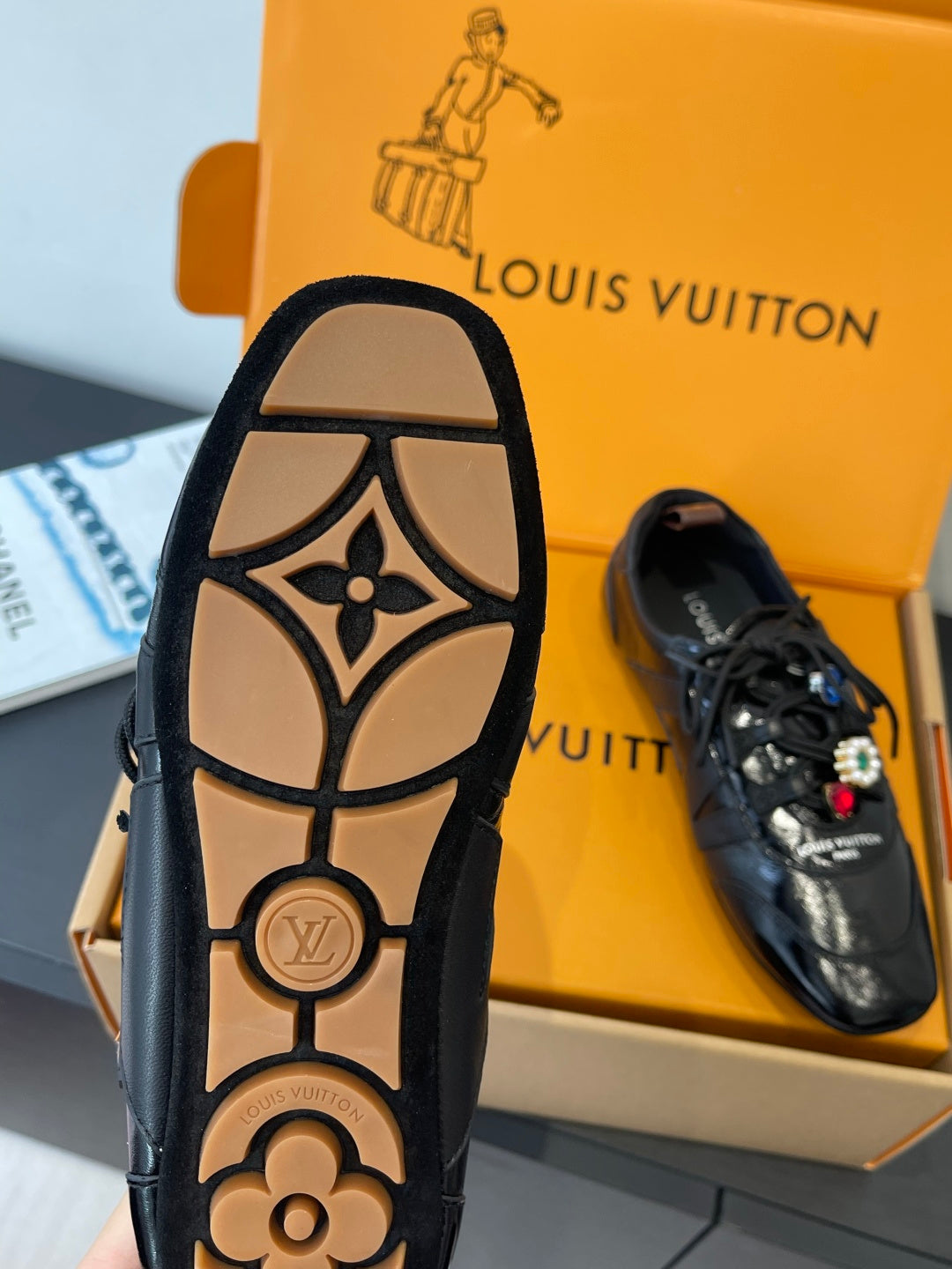 Louis Vuitton unisex sneaker outsole view with dark tread and logo stamp