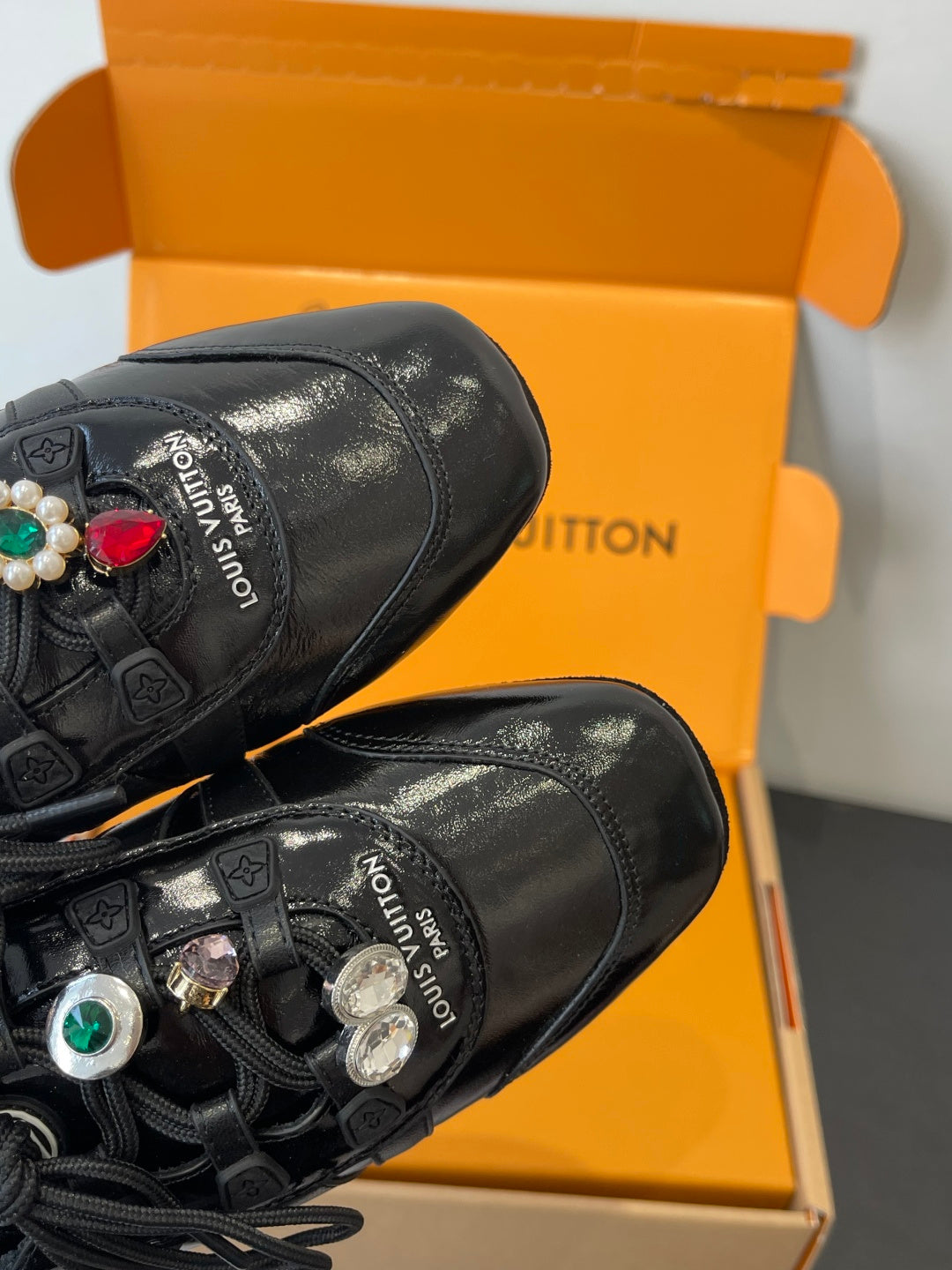 Louis Vuitton unisex black lace-up sneakers close-up of toe and logo patches