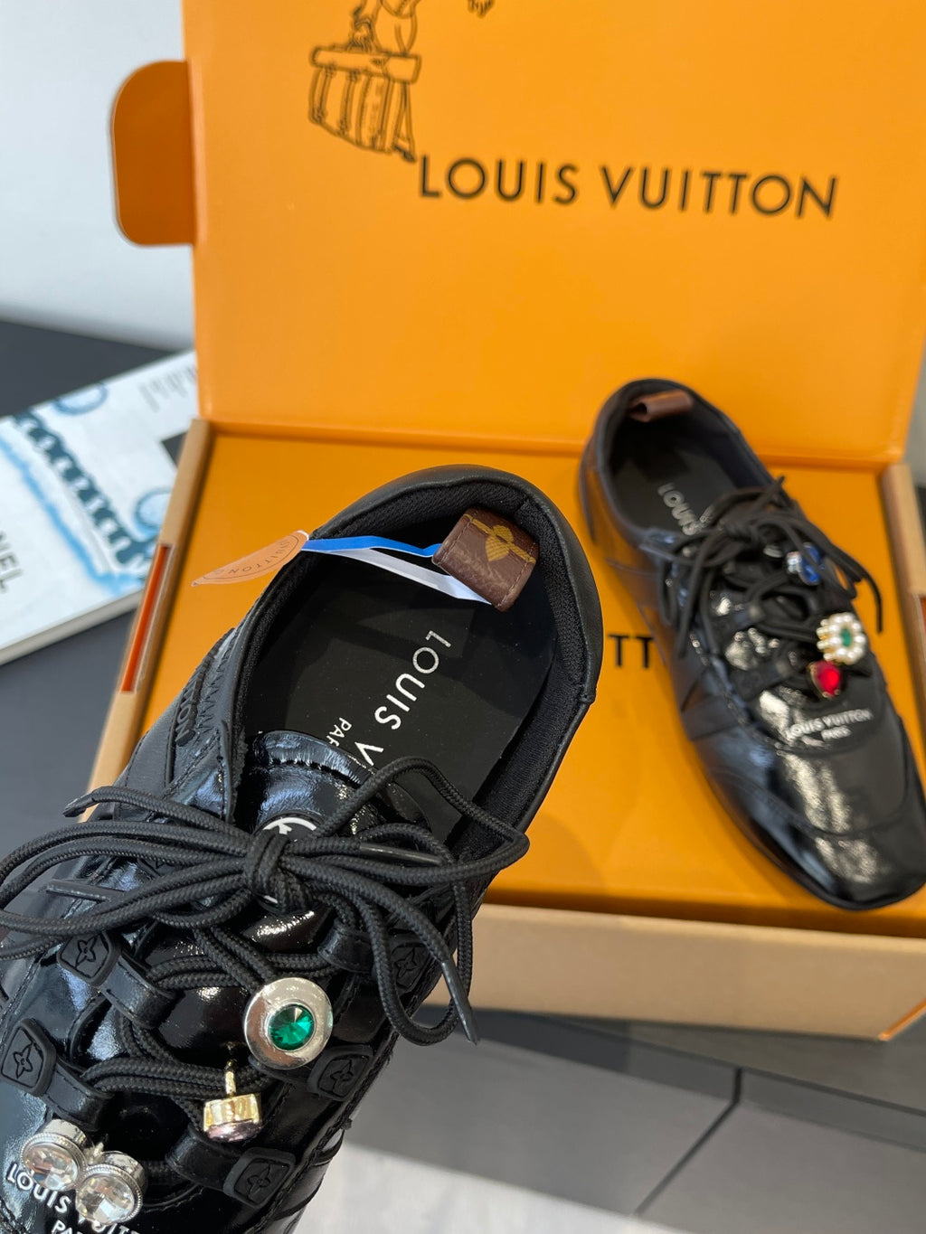 Louis Vuitton unisex black lace-up sneaker toe and heel detail, charm accents