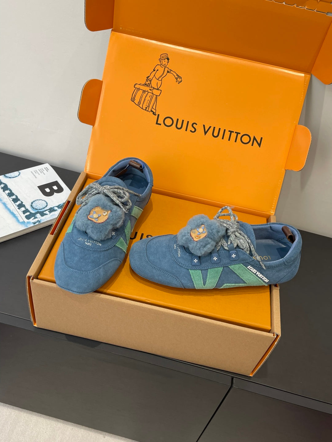Unisex blue suede sneakers with bear-face patches and green stripe, side view
