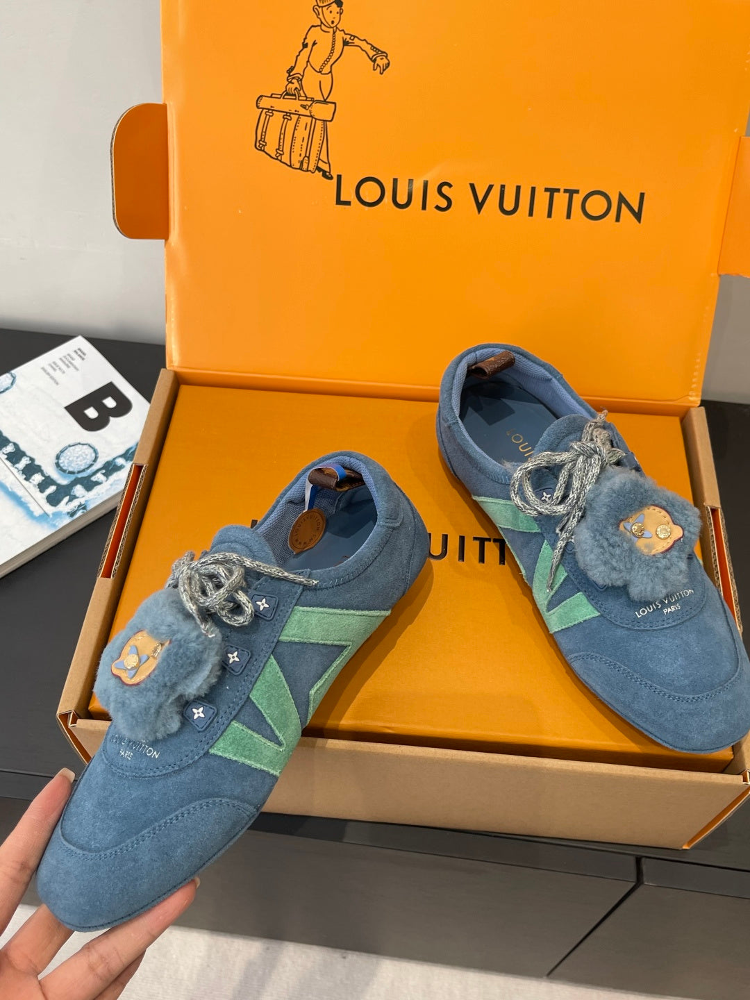 Unisex blue suede sneakers with lace-up bow and bear-face patch, side angle