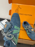 Unisex blue suede sneaker with fuzzy tongue and bear-face patch, green stripe
