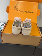Pair of beige suede sneakers with pink laces and fur-trimmed cuffs in box