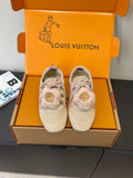 Pair of light beige suede sneakers with pink laces and faux-fur trim