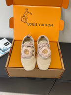 Pair of light beige suede sneakers with pink laces and faux-fur trim