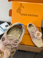 Light beige sneaker interior view with pink-lace tie and fur-trimmed cuff