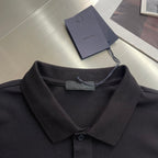 Prada polo shirt neckline close-up, dark fabric with folded collar and button