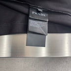 Prada polo shirt label and collar seam, dark fabric with attached tag