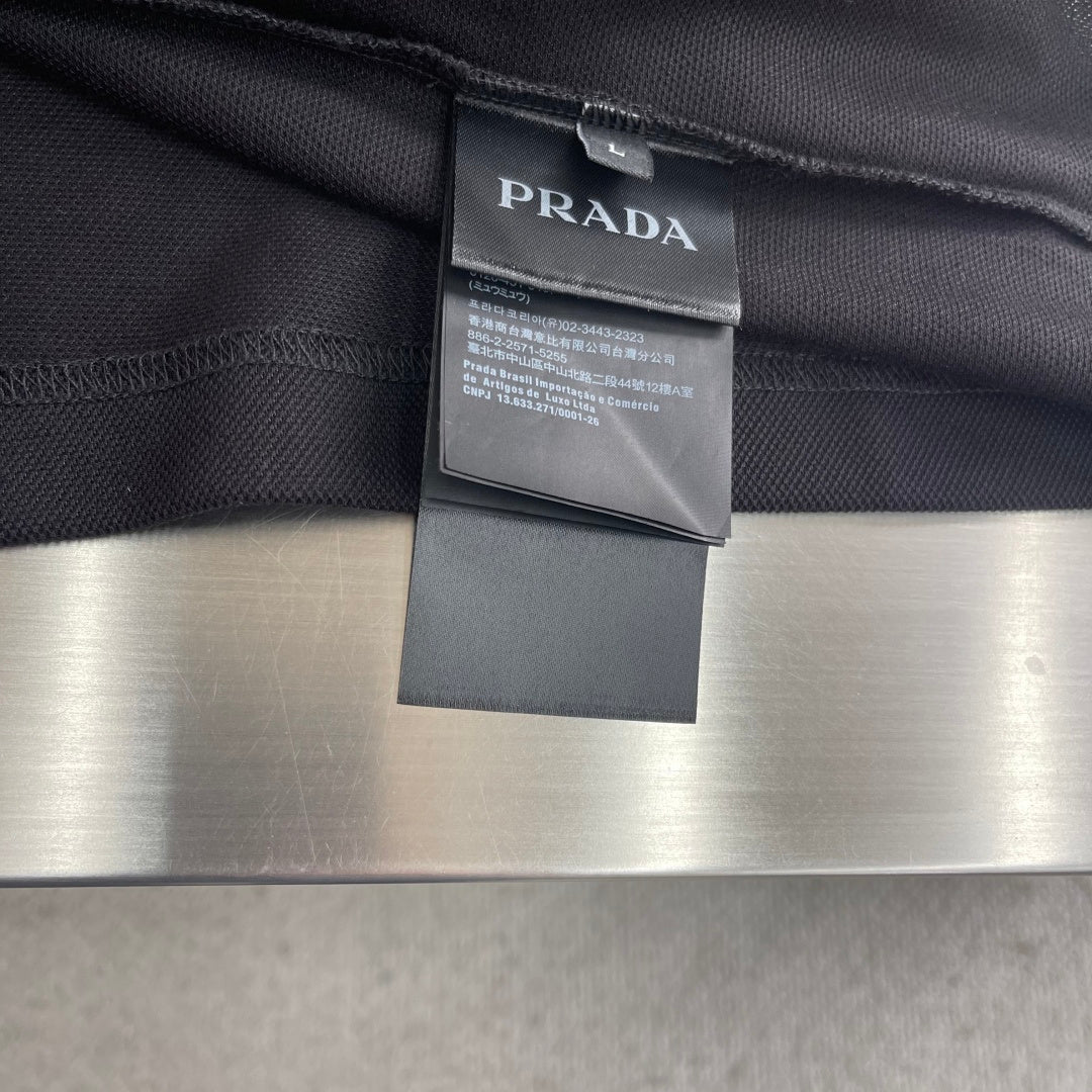 Prada polo shirt label and collar seam, dark fabric with attached tag