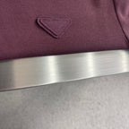 Prada polo shirt logo embroidery on burgundy chest, close-up