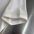 Prada polo shirt hem and sleeve cuff in off-white, folded edge detail.