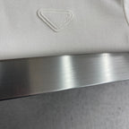 Prada polo shirt chest logo embroidery on off-white fabric.