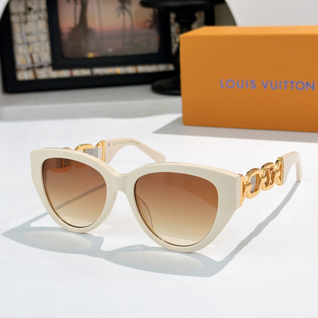 Louis Vuitton cat-eye sunglasses with cream frame, tan lenses, gold chain detail