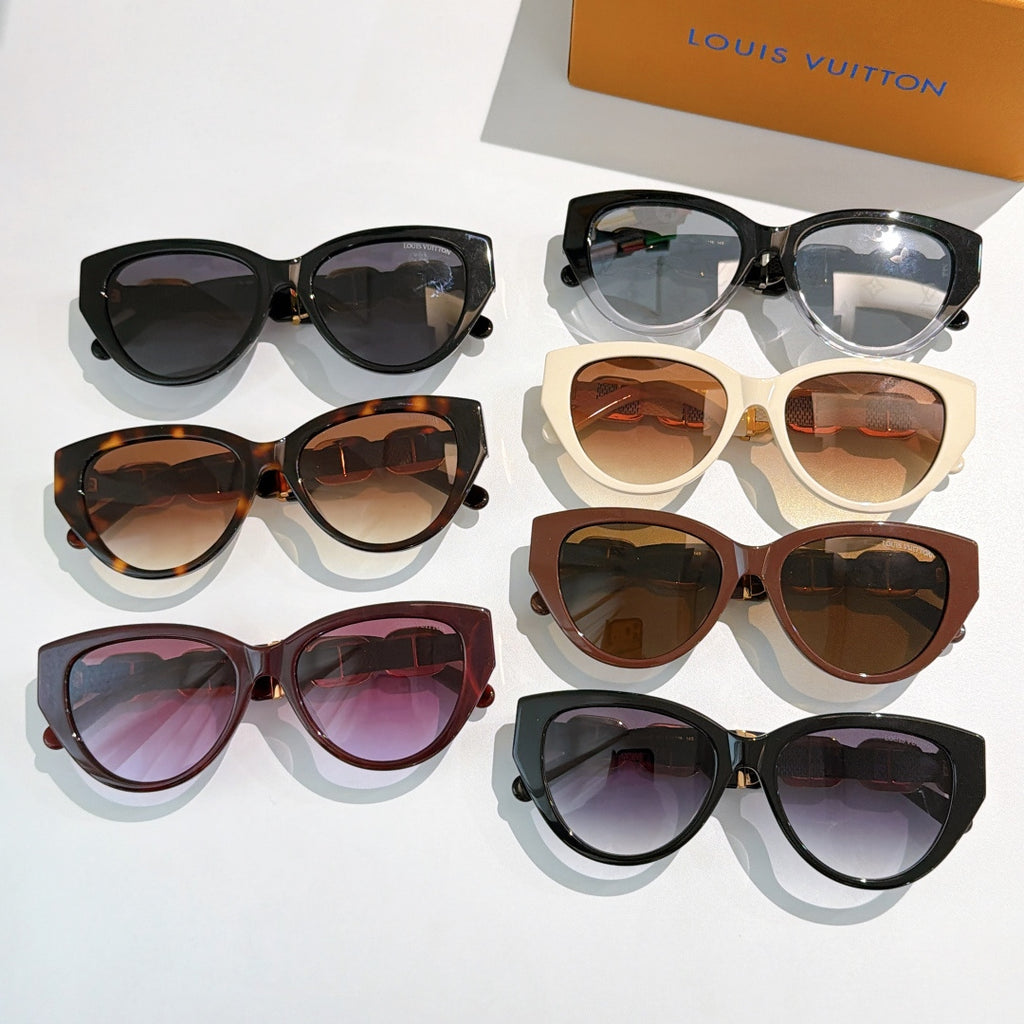Assorted cat-eye sunglasses, black, tortoiseshell, cream, and brown frames with tinted lenses