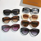 Assorted cat-eye sunglasses, black, tortoiseshell, cream, and brown frames with tinted lenses