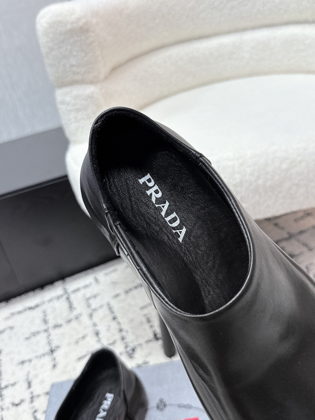 Black leather loafer interior view with PRADA printed on insole
