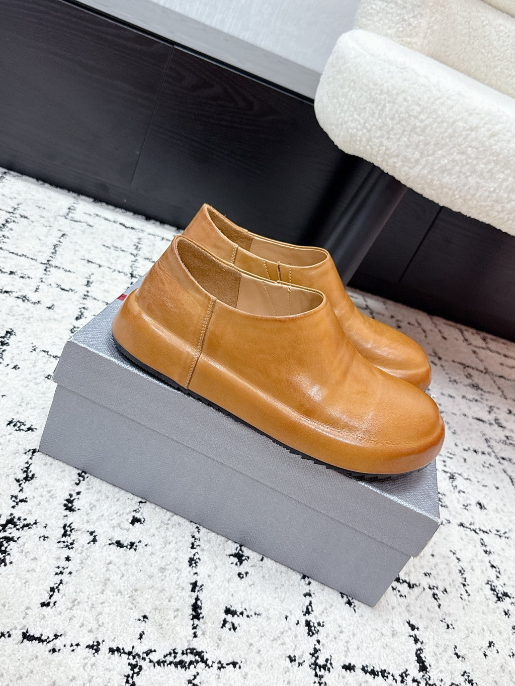 Brown leather slip-on loafers with rounded toe and smooth upper.