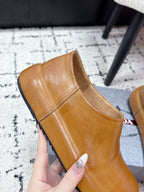 Brown leather slip-on loafer with rounded toe; side seam detail.