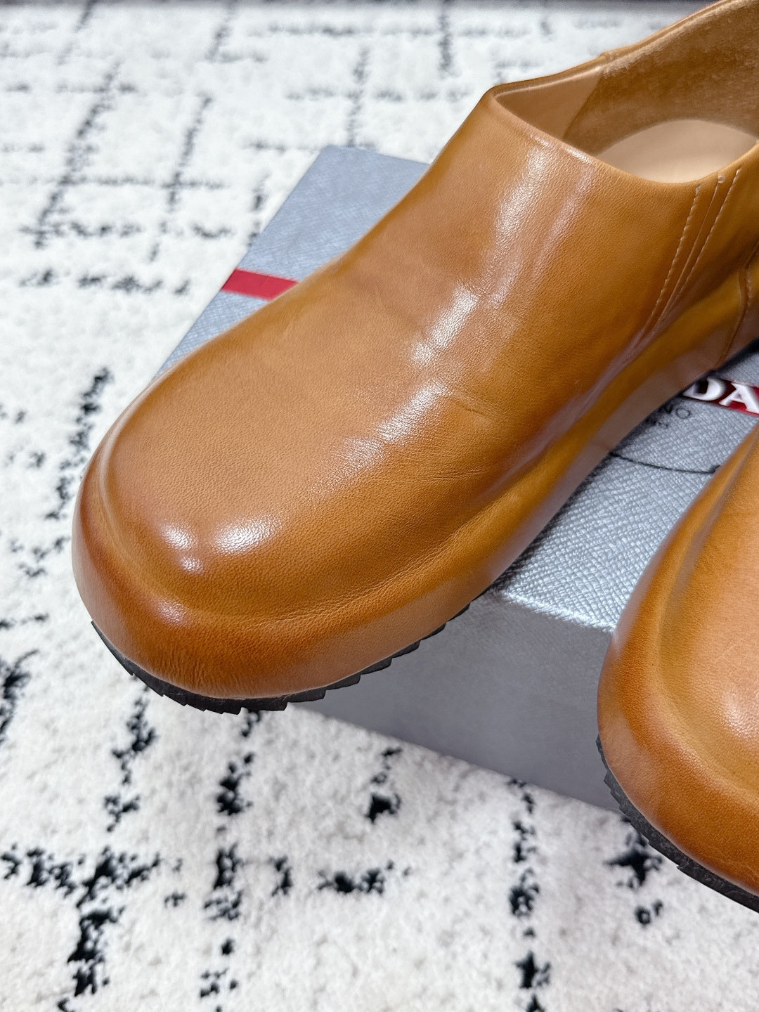 Brown leather slip-on loafer with rounded toe and smooth upper.
