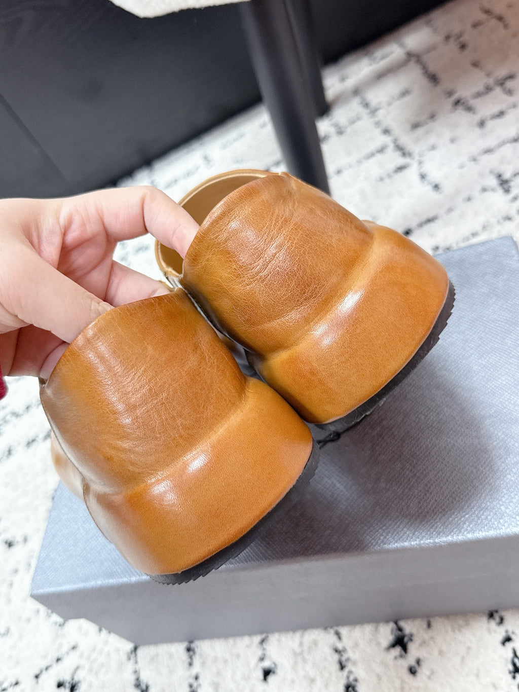 Brown leather slip-on loafers shown from toe and heel angle.
