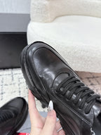 Prada unisex leather lace-up sneakers, dark black, toe and lace detail