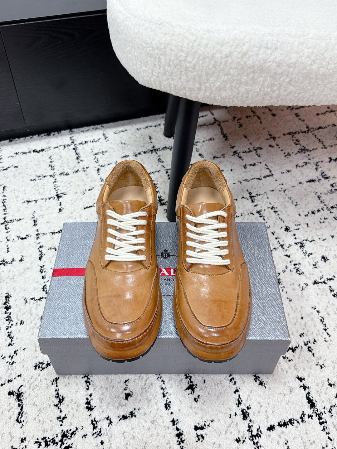 Tan unisex Prada leather sneakers with white lace-up and rubber sole