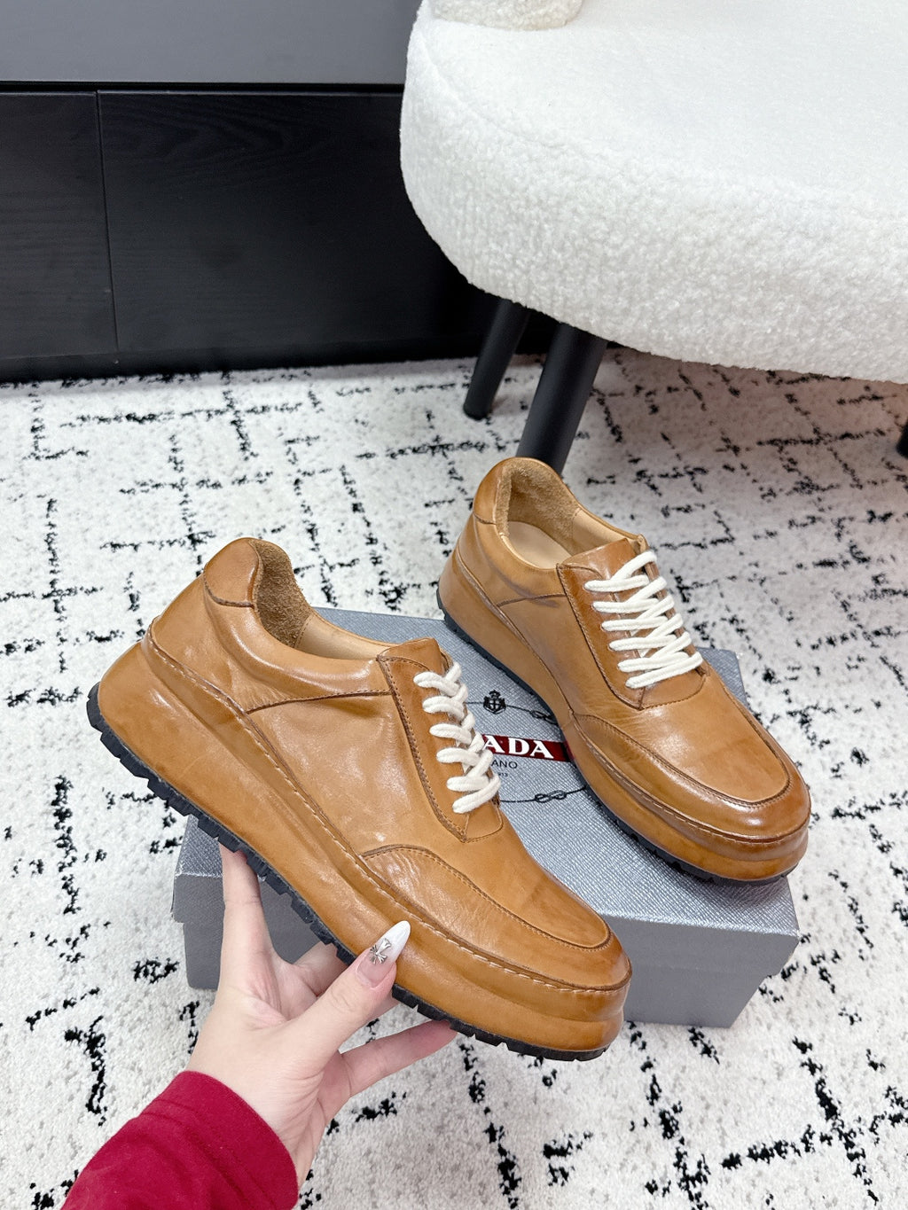 Tan unisex Prada leather low-top sneakers, angled view with white laces