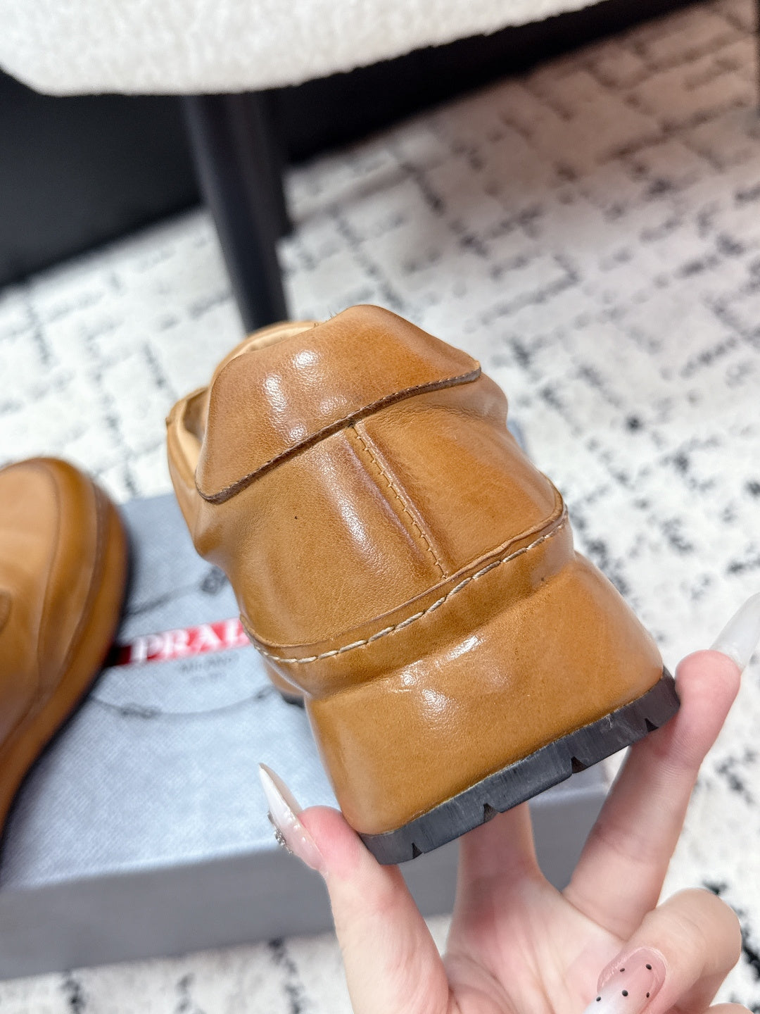 Tan Prada leather sneaker heel and side stitching with white laces