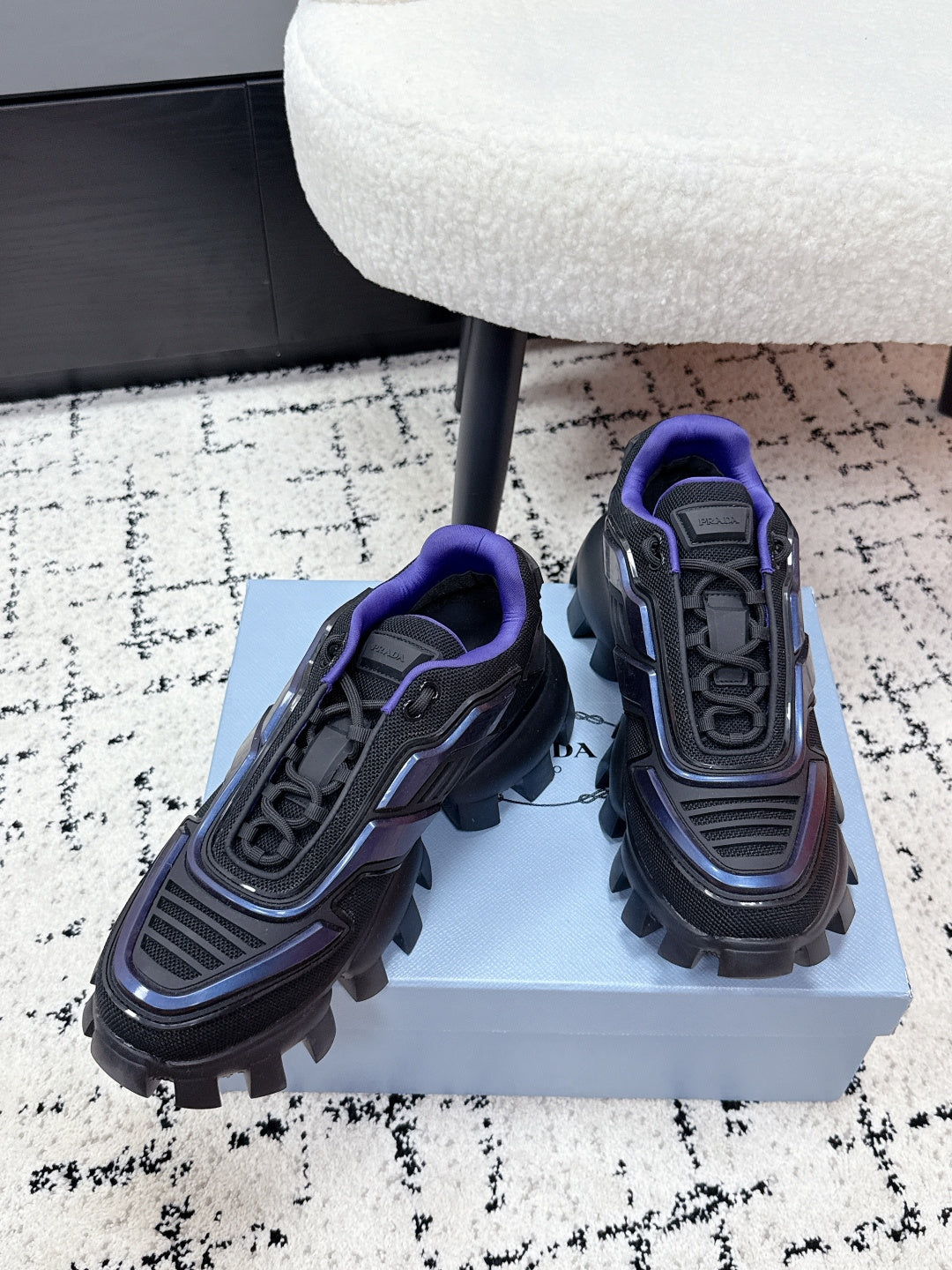Prada unisex shoes angled view, dark gray with blue piping and purple collar