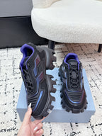 Prada unisex shoes on box, dark gray with blue panels and purple laces