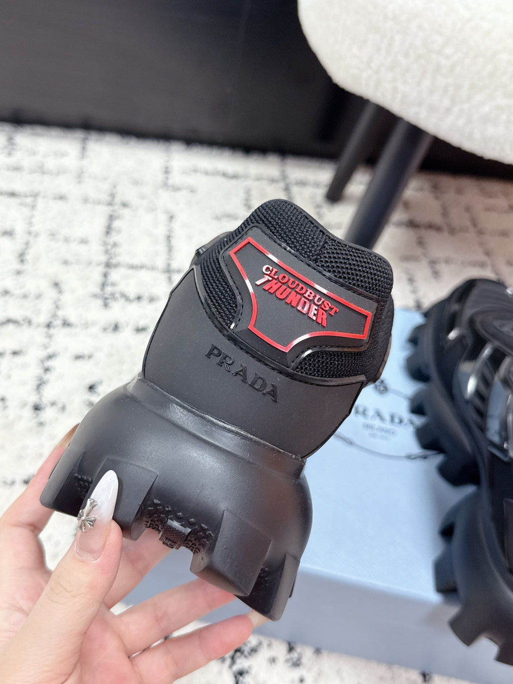 Prada unisex sneakers, black heel close-up with Cloudburst label and chunky sole