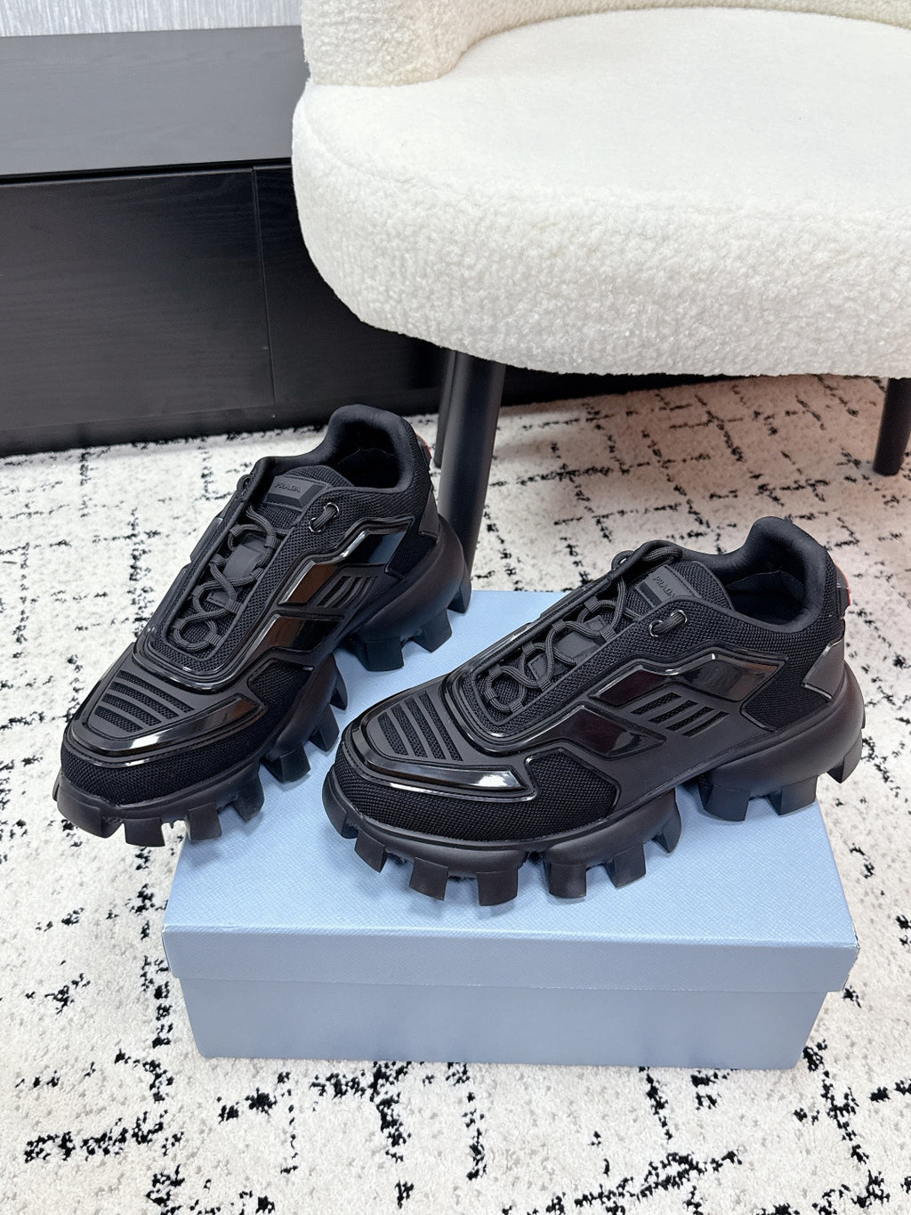 Prada unisex sneakers, black, side view with lace-up detailing and rugged outsole