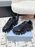 Prada unisex sneakers, black, side view with lace-up detailing and rugged outsole