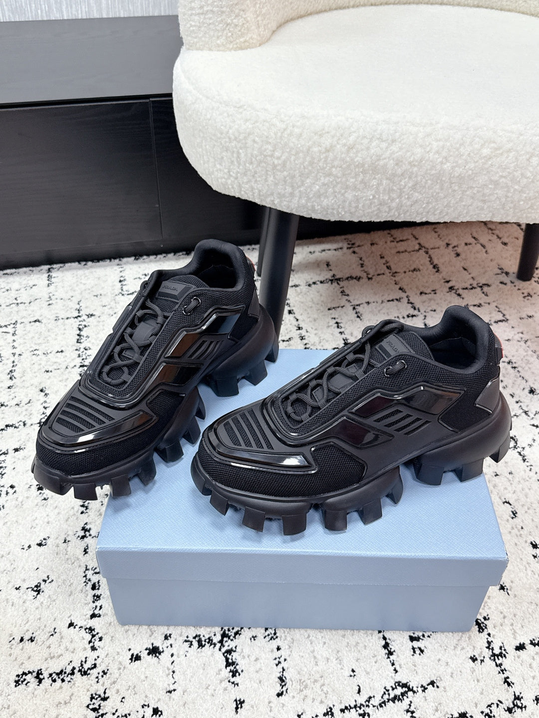 Prada unisex sneakers, black, side view with lace-up detailing and rugged outsole