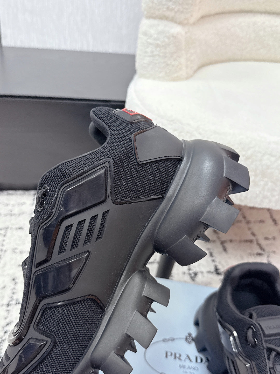 Prada unisex sneakers, black, close-up of heel and side mesh with sculpted sole lugs