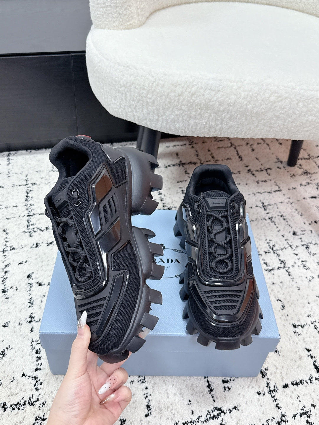 Prada unisex sneakers, black, heel and side view with bold panels and chunky lugs