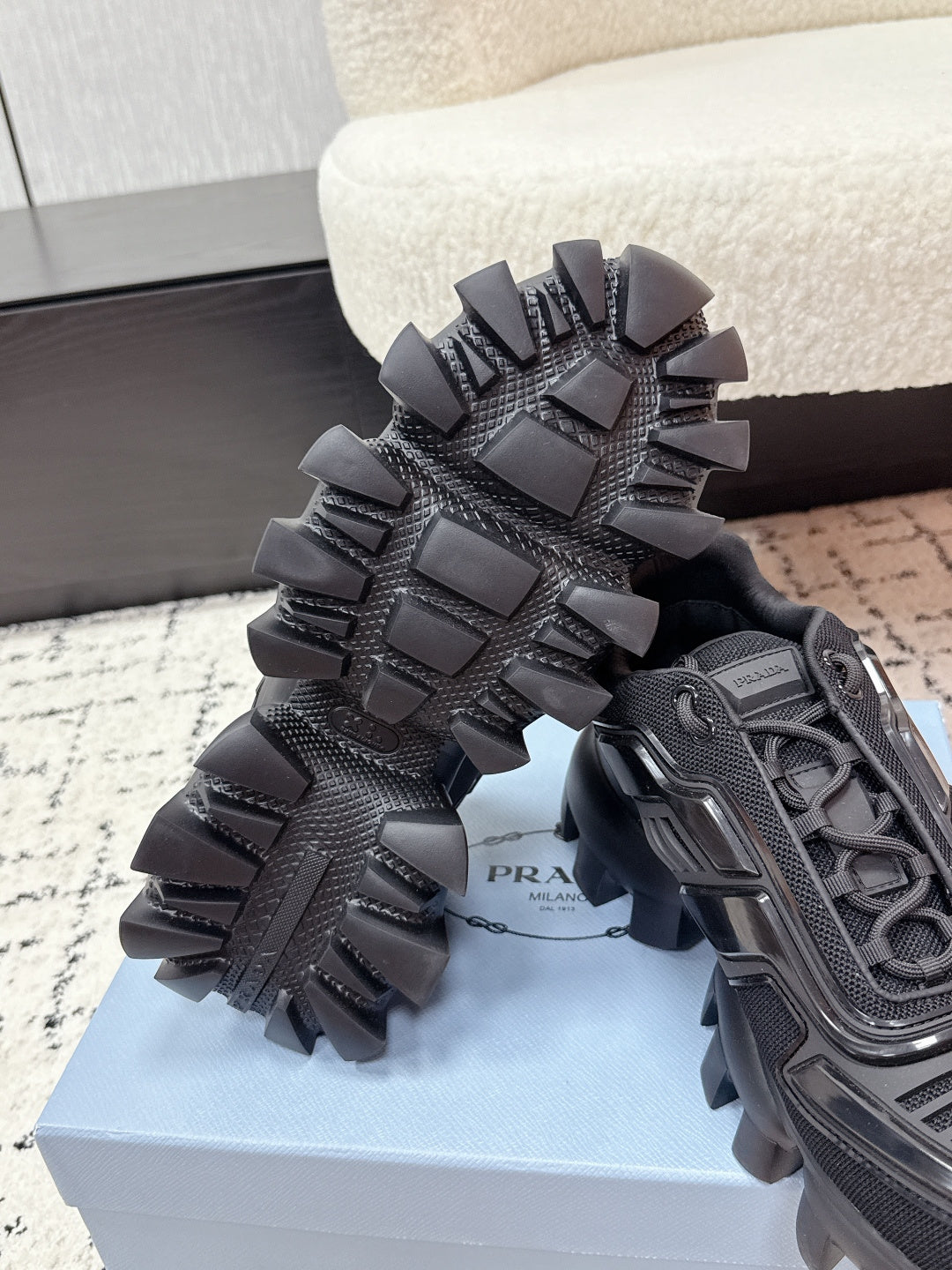 Prada unisex sneakers, black, top view of studded outsole and lace-up upper