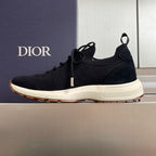 Black knit sneaker, lace-up style with white midsole and Dior branding on side.