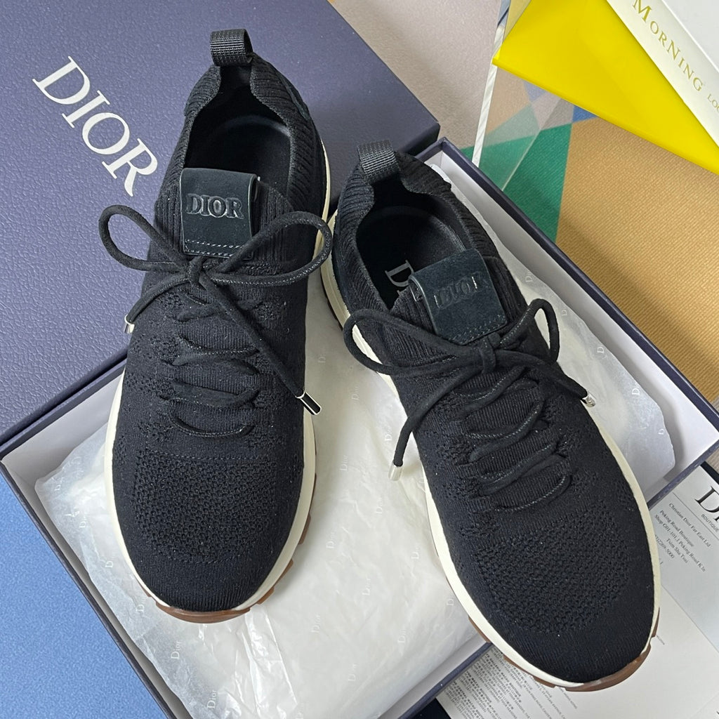 Black sock-style sneakers with lace-up closure, Dior patch on heel.