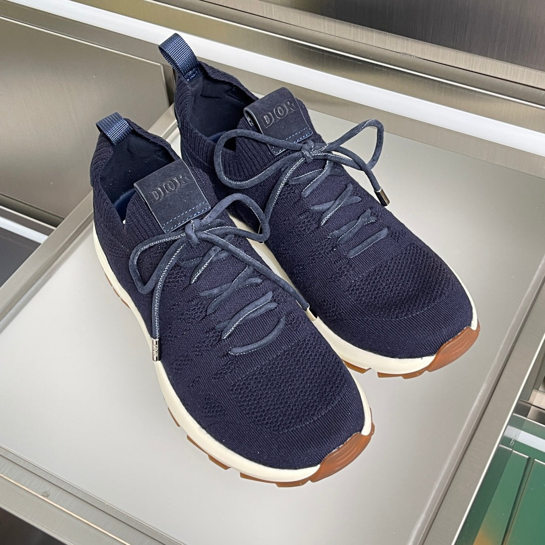 Pair of dark navy unisex sneakers with lace-up fronts and white rubber soles
