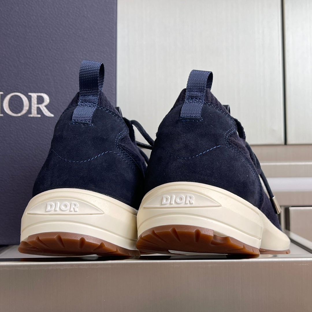 Dark navy unisex sneakers from heel view with DIOR logo and white rubber soles