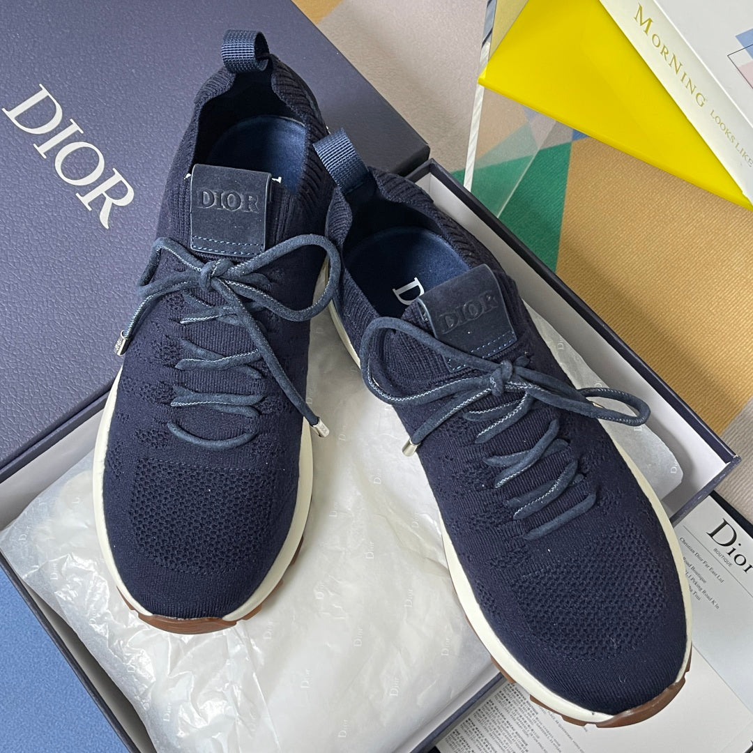 Navy unisex lace-up sneakers with knit texture, lace aglets, and white outsole