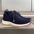 Dark navy unisex sneakers with knit upper, lace-up front, and white rubber sole