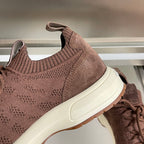 Dior unisex sneaker detail: dark brown knit panel, padded collar, and white sole